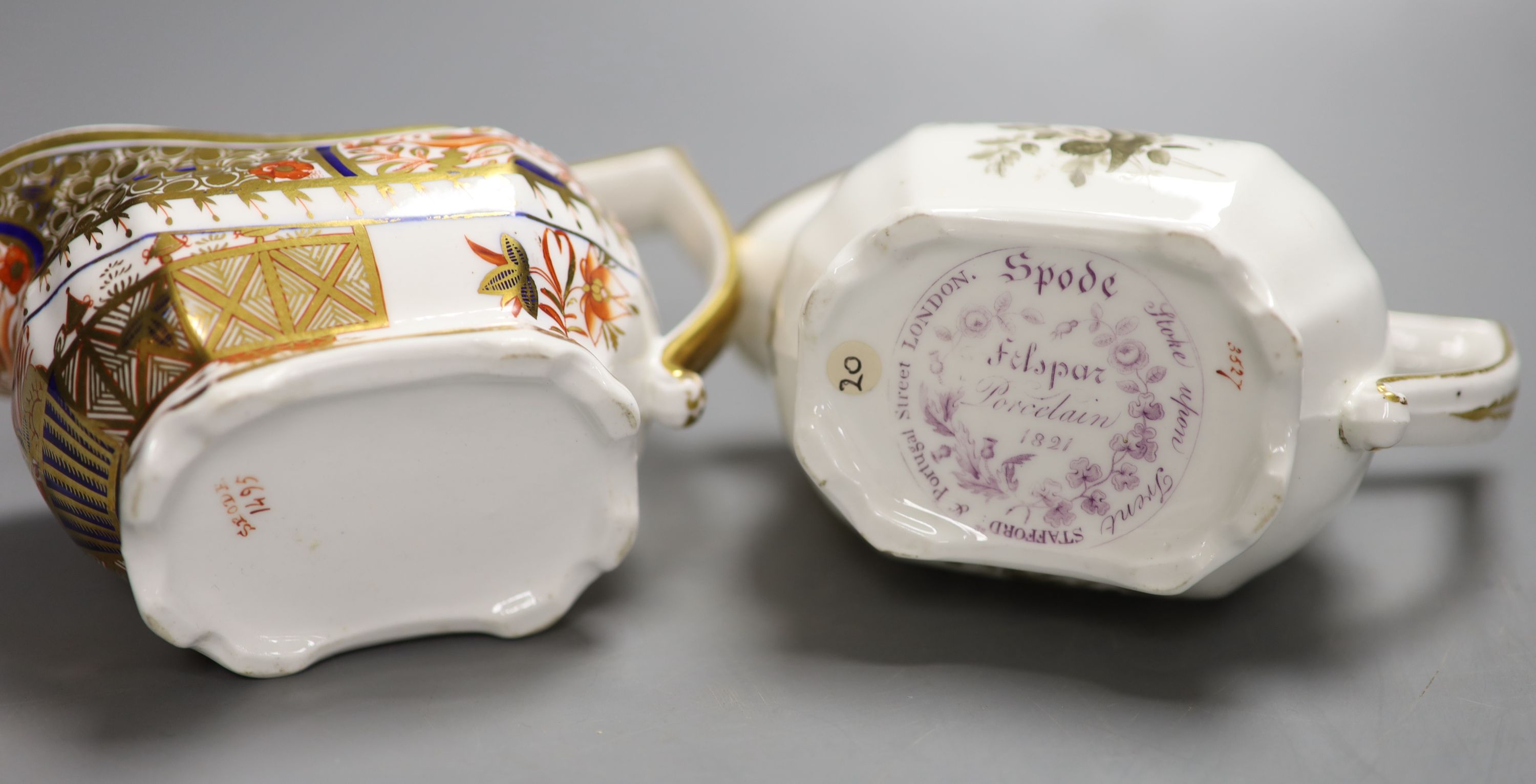 A Spode cream jug painted with Imari pattern 1495, and a Spode cream jug painted with sepia flowers under a gold border, pattern 3527,